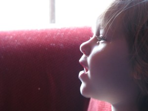 Child breathes dust particles from a couch