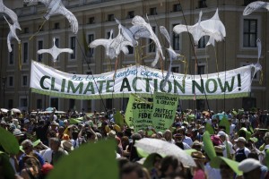 People hold a “Climate Action Now!” banner in St. Peter’s Square at the Vatican on June 28. (Andrew Medichini/The Associated Press)