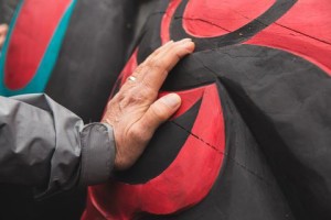 Viewers touch the totem on its stop at University Congregational UCC. Image: Matthew S. Browning/Real Change News